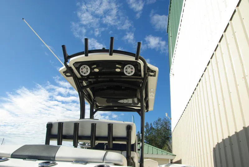 Slide: The Image of 2018 Wellcraft 222 Scarab Offshore boat with T-top against blue sky and clouds. - 10