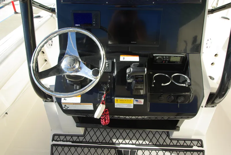 Slide: The Image of 2018 Wellcraft 222 Scarab Offshore boat dashboard with steering wheel and controls. - 14