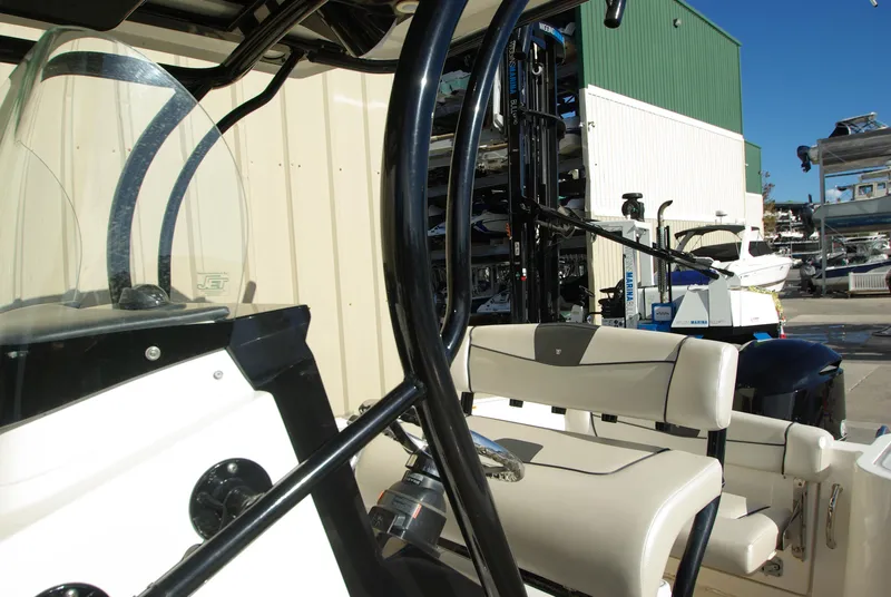 Slide: The Image of 2018 Wellcraft 222 Scarab Offshore boat interior with seating and controls. - 17