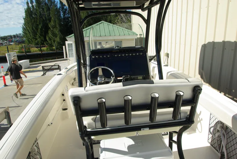 Slide: The Image of 2018 Wellcraft 222 Scarab Offshore boat interior with steering console and rod holders. - 19