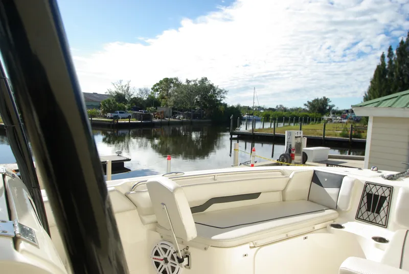 Slide: The Image of 2018 Wellcraft 222 Scarab Offshore boat interior at a serene dockside location. - 27