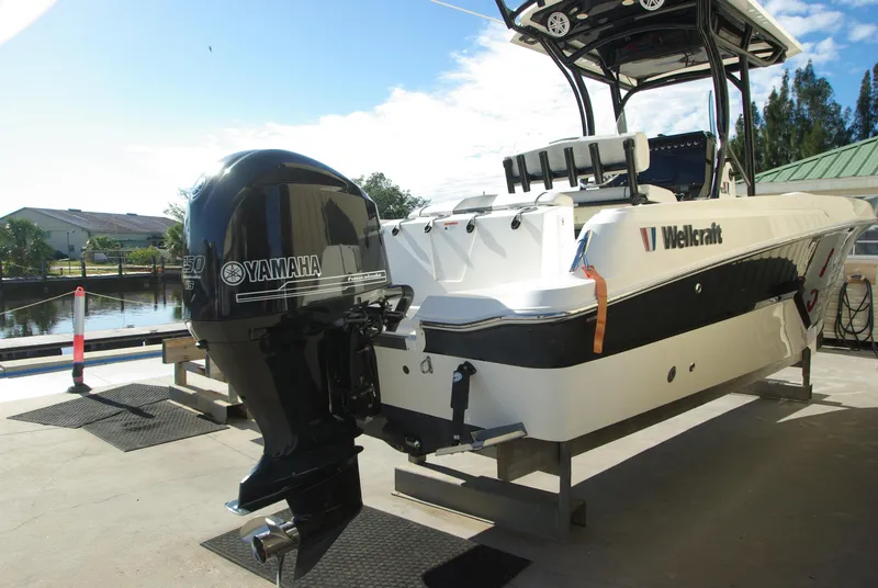 Slide: The Image of 2018 Wellcraft 222 Scarab Offshore boat with Yamaha outboard motor, docked near a canal. - 4