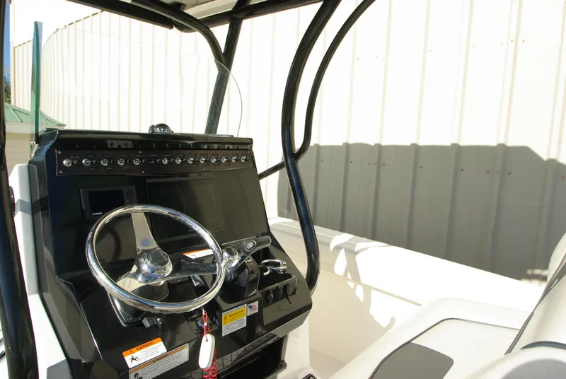 Slide: The Image of 2018 Wellcraft 222 Scarab Offshore boat console with steering wheel and controls. - 13