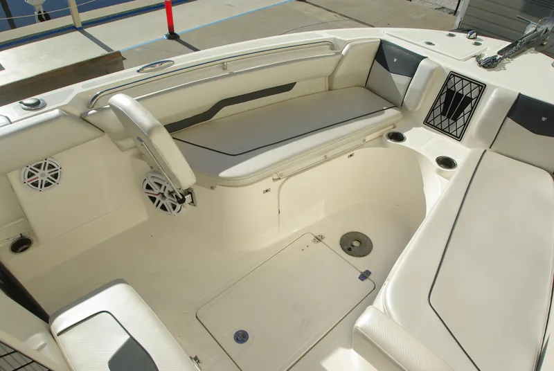 Slide: The Image of 2018 Wellcraft 222 Scarab Offshore boat interior with white seating and speakers. - 29