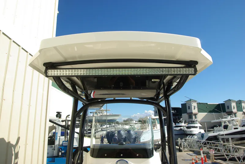 Slide: The Image of 2018 Wellcraft 222 Scarab Offshore boat with T-top, docked at marina. - 6