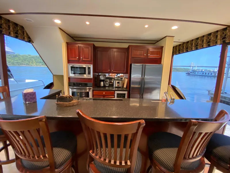 Slide: The Image of Luxurious 2005 Skipperliner Millenium yacht interior with modern kitchen and scenic water views. - 11