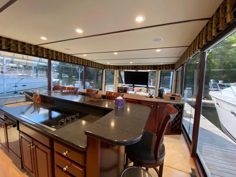 Slide: The Image of Luxurious kitchen in 2005 Skipperliner Millenium yacht with stainless steel appliances and wooden cabinetry. - 13