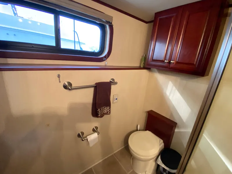 Slide: The Image of Bathroom in 2005 Skipperliner Millenium with shower, vanity, and mirror. - 24