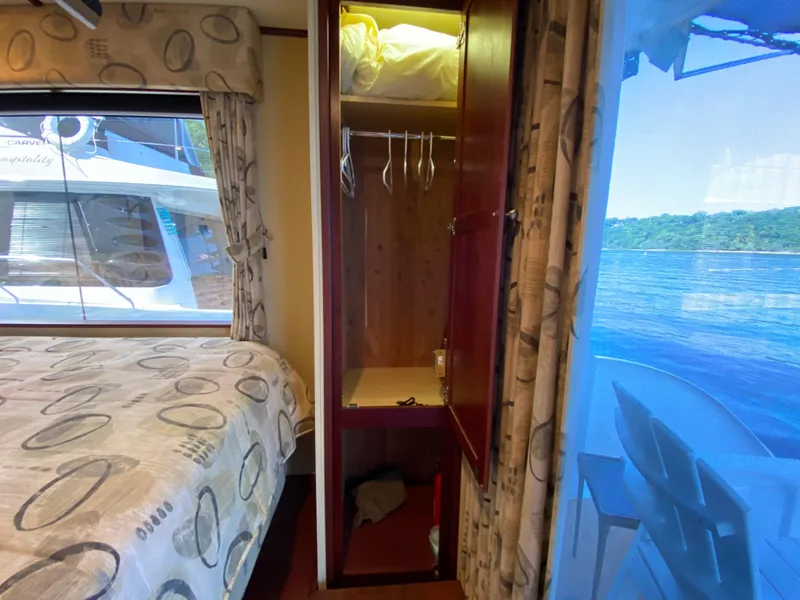 Slide: The Image of Cozy bedroom in 2005 Skipperliner Millenium houseboat with patterned bedding and window view. - 28