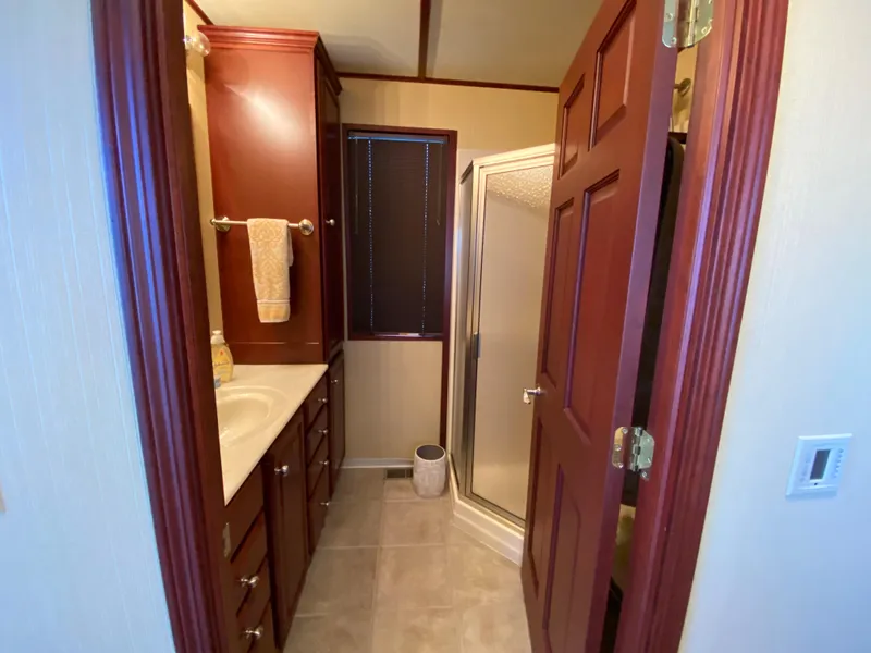 Slide: The Image of Luxurious bathroom in 2005 Skipperliner Millenium with wooden cabinets and modern fixtures. - 31