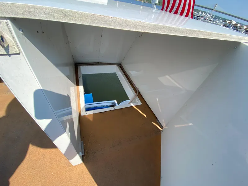 Slide: The Image of 2005 Skipperliner Millenium boat deck with blue seating, American flag, and scenic water view. - 36