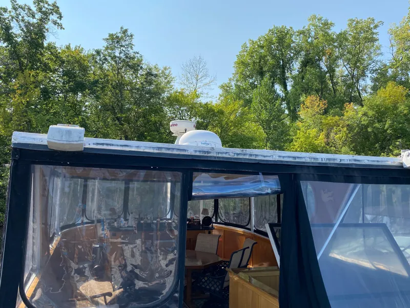 Slide: The Image of 2005 Skipperliner Millenium boat with blue cushioned seating and enclosed cabin area. - 39