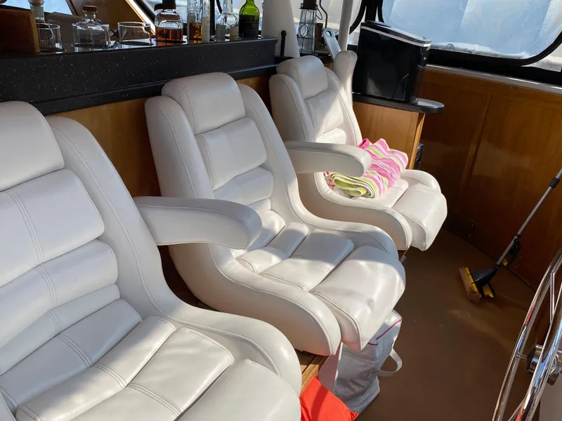 Slide: The Image of 2005 Skipperliner Millenium helm with steering wheel, controls, and wooden cabinetry. - 44