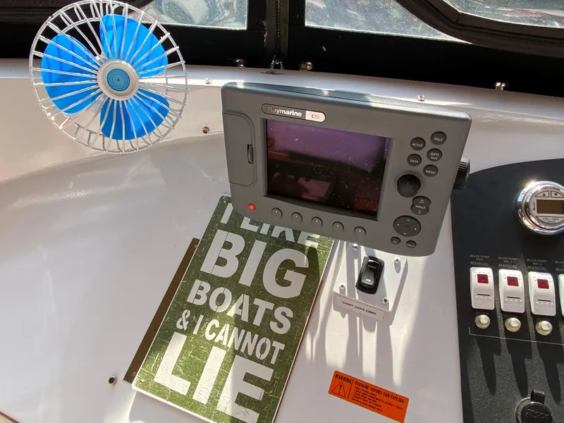 Slide: The Image of 2005 Skipperliner Millenium interior with fan and monitor on wooden panel. - 48