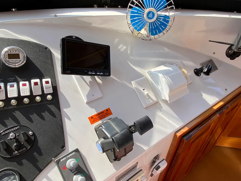 Slide: The Image of Control panel of a 2005 Skipperliner Millenium with a humorous sign and navigation equipment. - 49