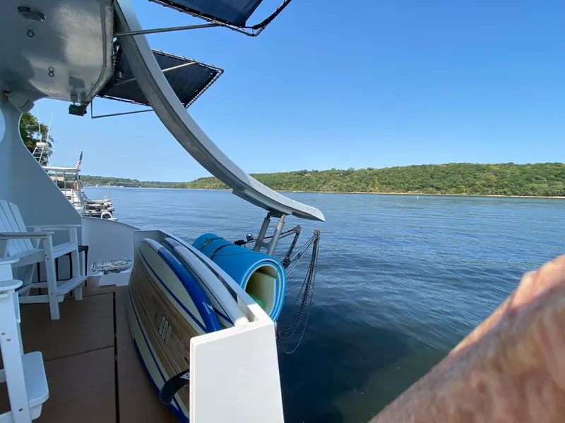 Slide: The Image of 2005 Skipperliner Millenium docked by a serene lake with lush green shoreline. - 5