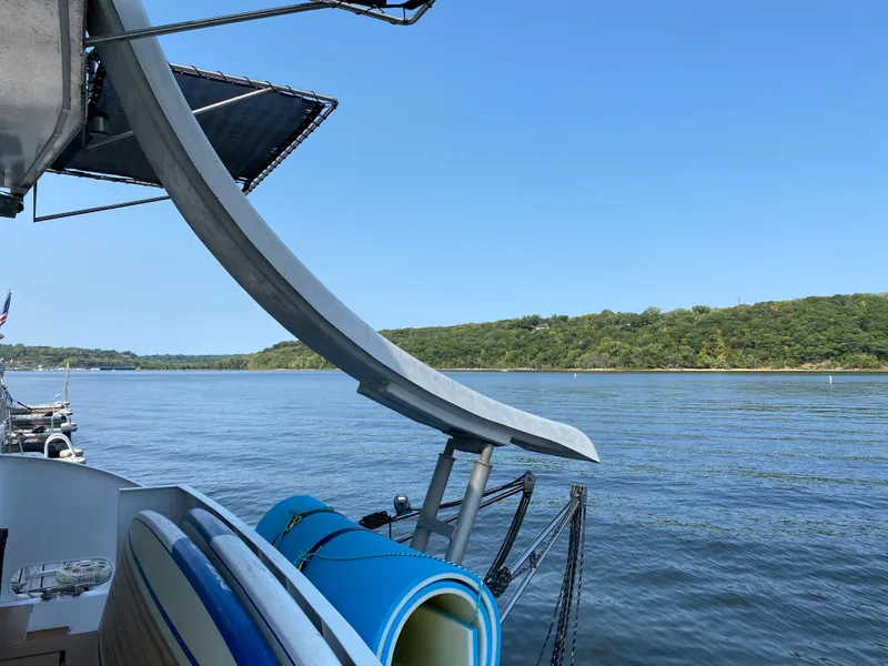 Slide: The Image of 2005 Skipperliner Millenium boat deck with white chairs overlooking serene water and distant shoreline. - 7