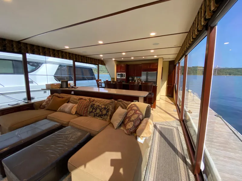 Slide: The Image of 2005 Skipperliner Millenium boat with slide, docked on a calm lake with lush green shoreline. - 8