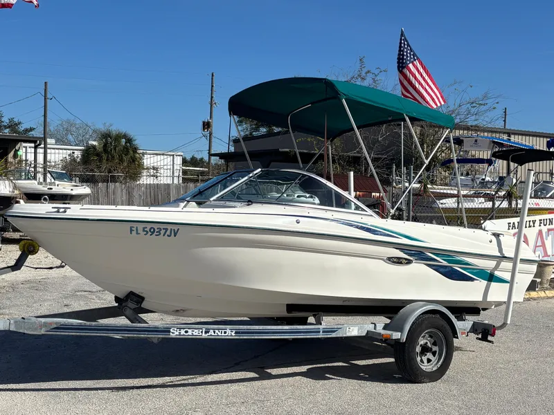 Slide: The Image of 1998 Sea Ray 180 Bow Rider on trailer with canopy and American flag. - 12