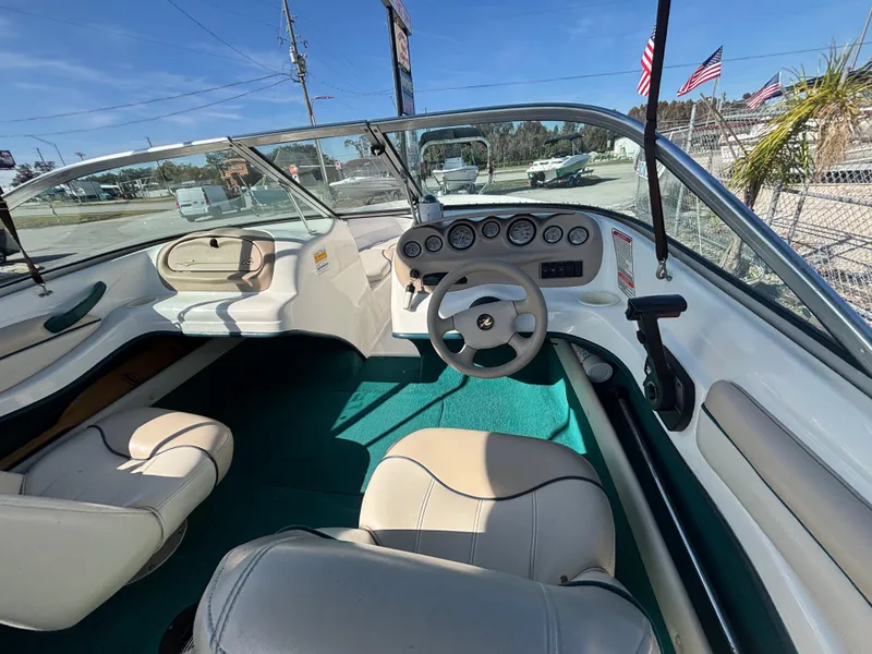 Slide: The Image of 1998 Sea Ray 180 Bow Rider interior with steering wheel and dashboard. - 21
