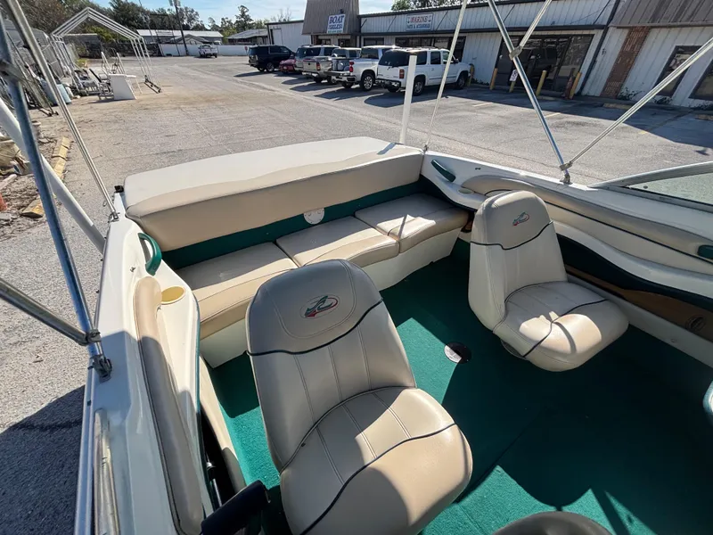 Slide: The Image of 1998 Sea Ray 180 Bow Rider interior with beige seats and green carpet. - 25