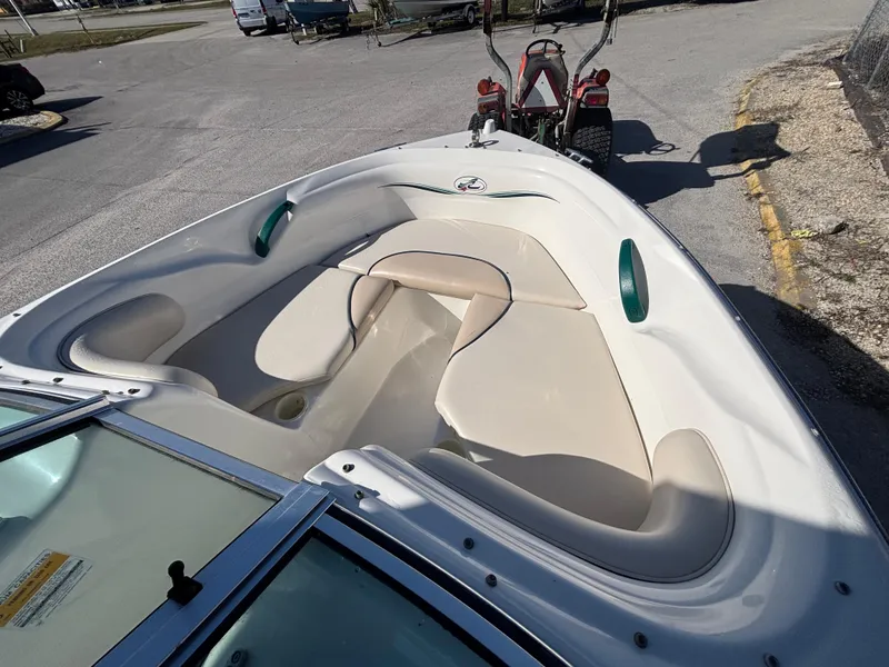 Slide: The Image of 1998 Sea Ray 180 Bow Rider boat interior with beige seating. - 26