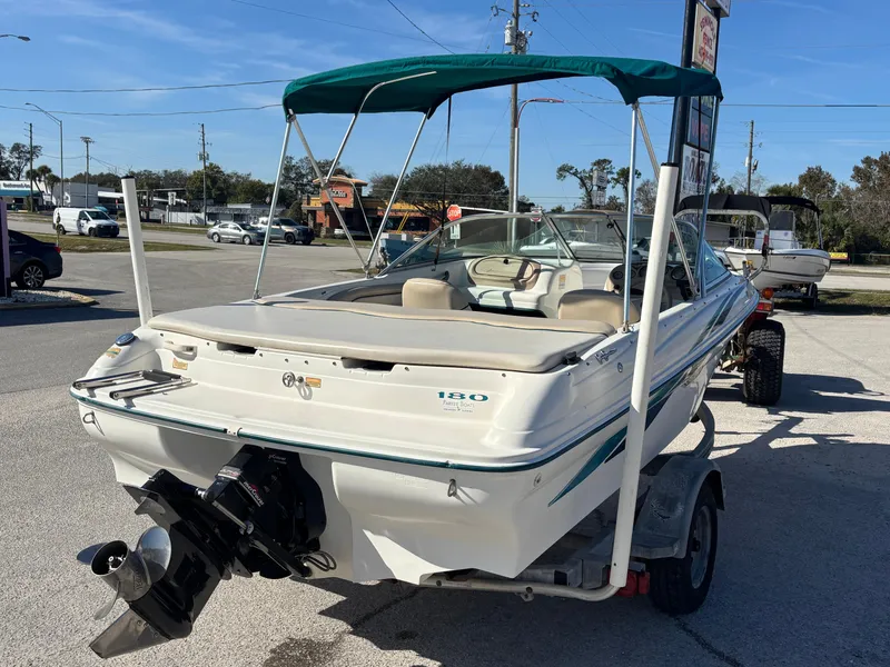 Slide: The Image of 1998 Sea Ray 180 Bow Rider boat on trailer, parked outdoors. - 6