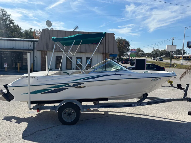 Slide: The Image of 1998 Sea Ray 180 Bow Rider boat on trailer, parked outdoors. - 8