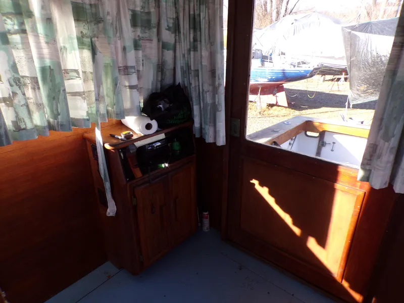 Slide: The Image of Interior of 1986 Jersey Dawn 40 boat with wooden paneling and curtains. - 11