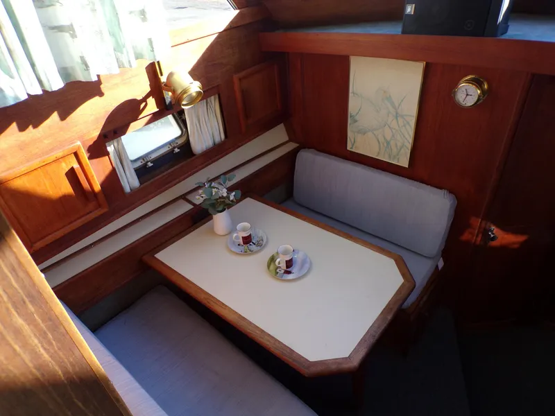 Slide: The Image of Cozy dining area in 1986 Jersey Dawn 40 boat with wooden interior and natural light. - 16