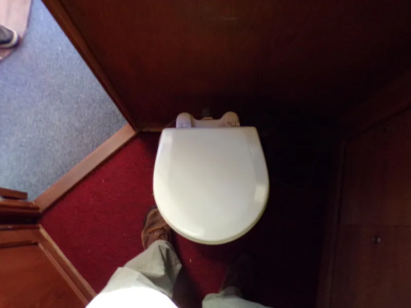 Slide: The Image of Compact bathroom with white toilet on a 1986 Jersey Dawn 40 boat. - 20