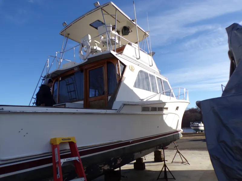 Slide: The Image of 1986 Jersey Dawn 40 boat on dry dock under clear blue sky. - 4