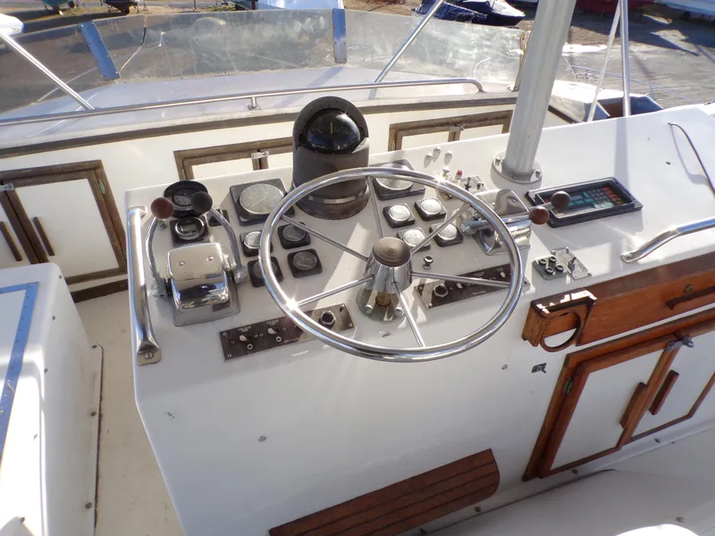 Slide: The Image of Control panel of a 1986 Jersey Dawn 40 boat with steering wheel and navigation instruments. - 7