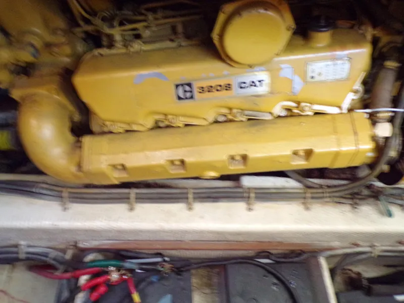 Slide: The Image of Engine of a 1986 Jersey Dawn 40 boat, featuring a yellow CAT 3208 diesel engine. - 8