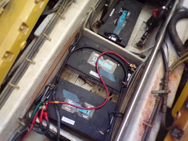 Slide: The Image of Battery compartment of a 1986 Jersey Dawn 40 boat with visible wiring and connections. - 9