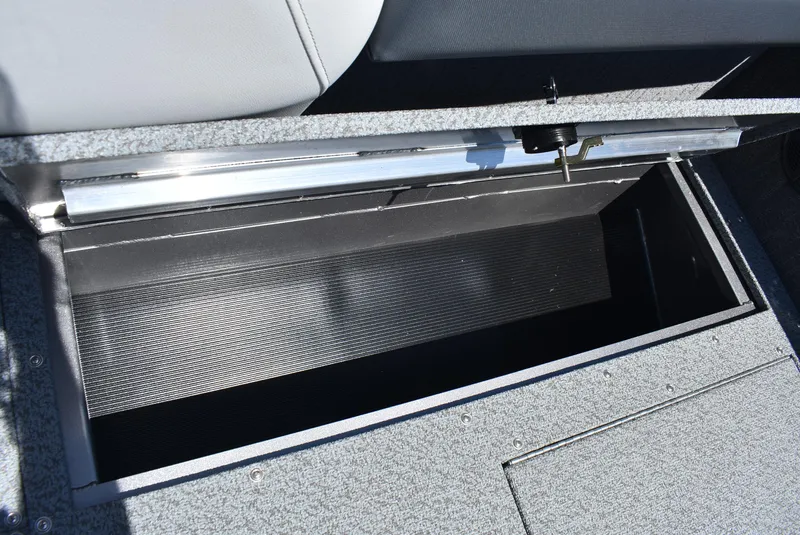 Slide: The Image of 2025 Lowe SD224 Sport Deck storage compartment, open and empty, with textured interior and gray exterior. - 10