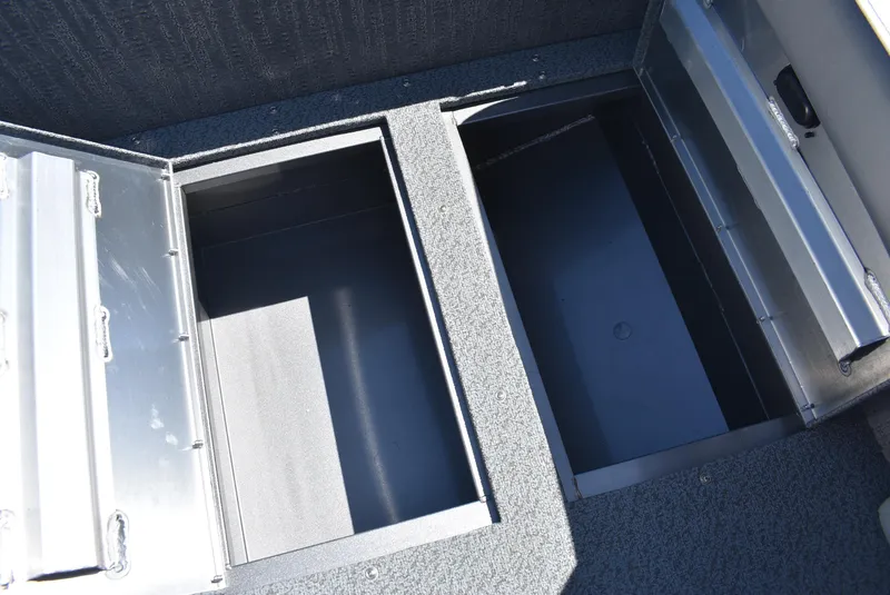 Slide: The Image of 2025 Lowe SD224 Sport Deck storage compartments, open and empty, showcasing interior space. - 11