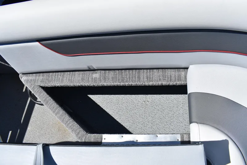 Slide: The Image of 2025 Lowe SD224 Sport Deck interior seating with storage compartment. - 16