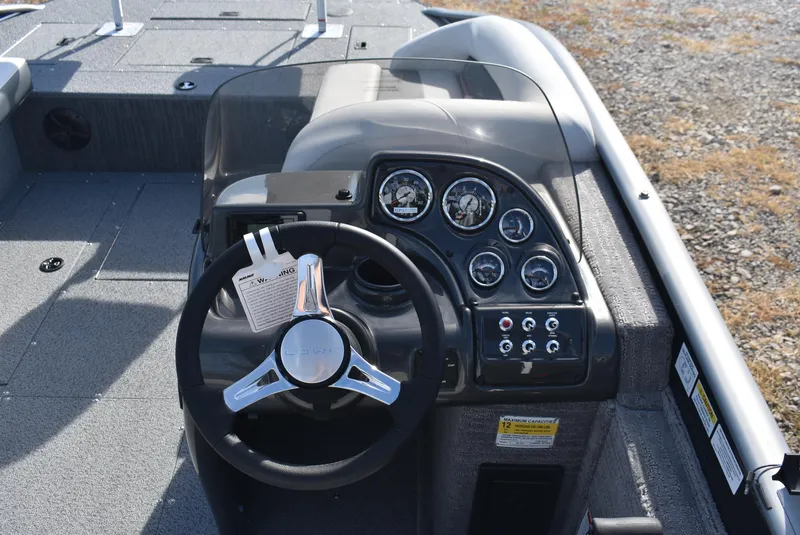 Slide: The Image of 2025 Lowe SD224 Sport Deck boat dashboard with steering wheel and gauges. - 7