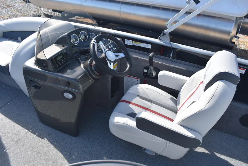 Slide: The Image of 2025 Lowe SD224 Sport Deck boat cockpit with steering wheel and comfortable seating. - 8