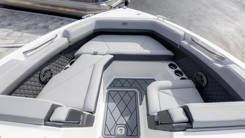 Slide: The Image of 2025 Cobalt R6 Outboard boat interior with gray seating and cup holders. - 11