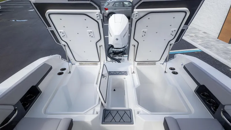 Slide: The Image of 2025 Cobalt R6 Outboard boat with open storage compartments and sleek design. - 18