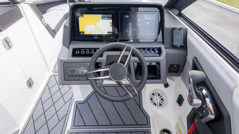 Slide: The Image of 2025 Cobalt R6 Outboard boat dashboard with modern controls and navigation screens. - 32
