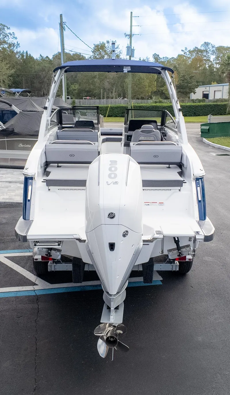 Slide: The Image of 2025 Cobalt R6 Outboard boat, rear view, parked on pavement. - 6