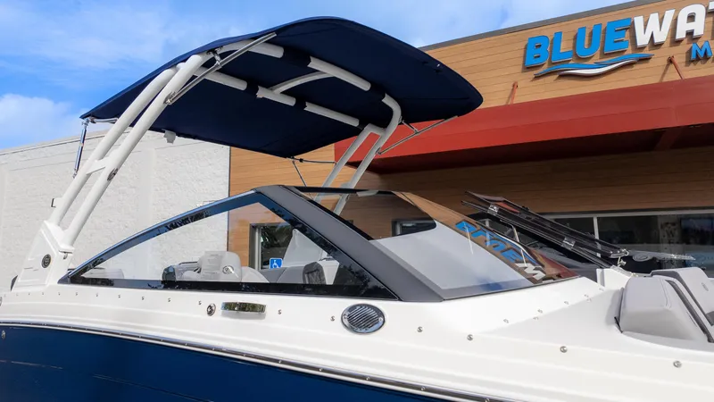 Slide: The Image of 2025 Cobalt R6 Outboard boat with blue canopy at Bluewater Marine dealership. - 8