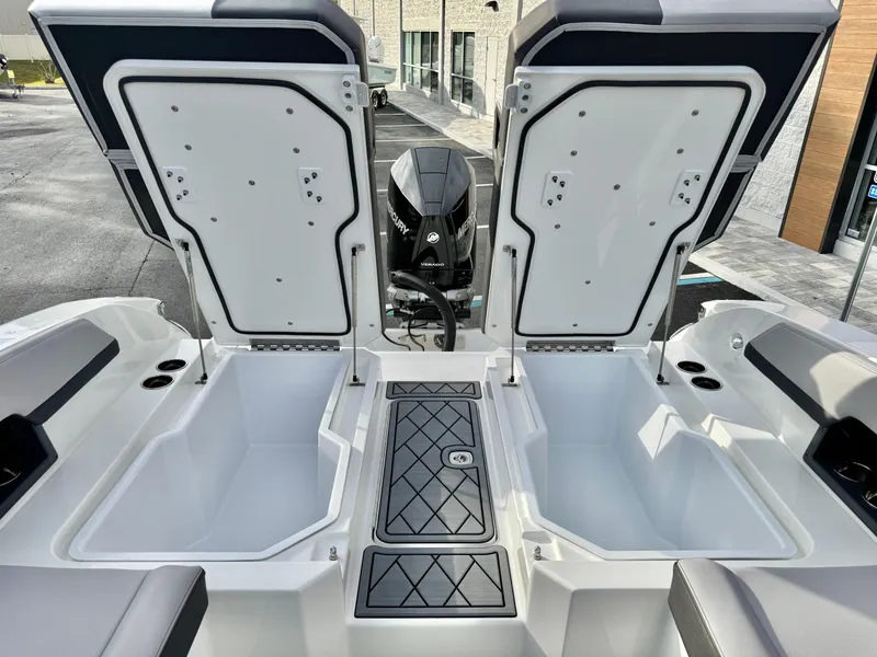 Slide: The Image of 2025 Cobalt R6 Outboard boat with open storage compartments and visible engine. - 27