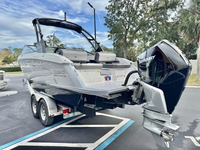 Slide: The Image of 2025 Cobalt R6 Outboard boat with Mercury engine on trailer in parking lot. - 8
