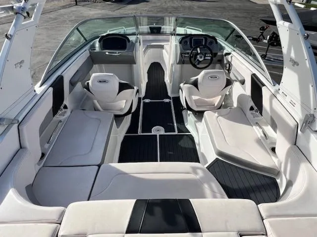 Slide: The Image of 2019 Chaparral 23 H2O Surf boat interior with seating and steering wheel. - 10