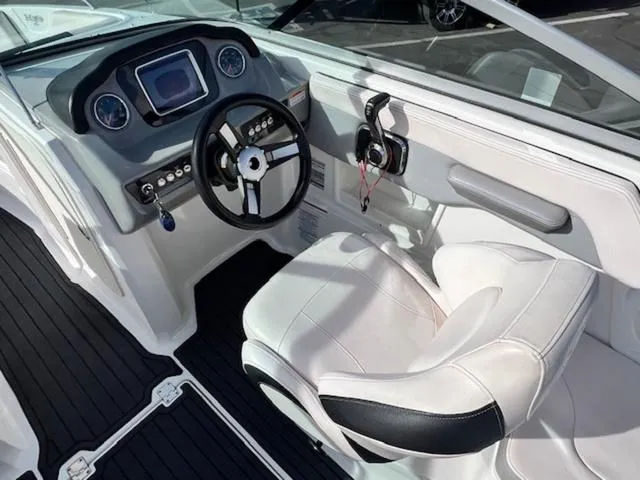 Slide: The Image of 2019 Chaparral 23 H2O Surf boat interior with steering wheel and dashboard. - 11