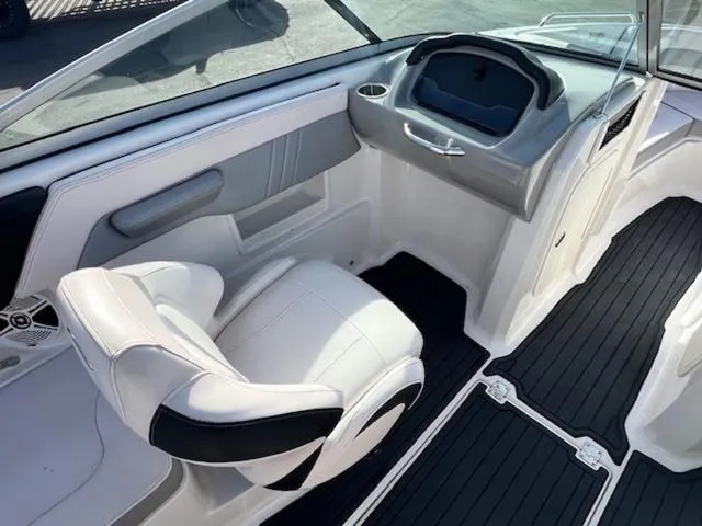 Slide: The Image of 2019 Chaparral 23 H2O Surf boat interior with white seating and black flooring. - 12